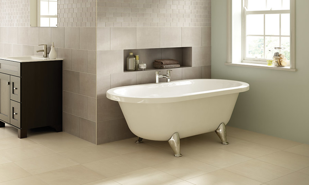 Cream tile flooring in a bathroom with a clawfoot tub