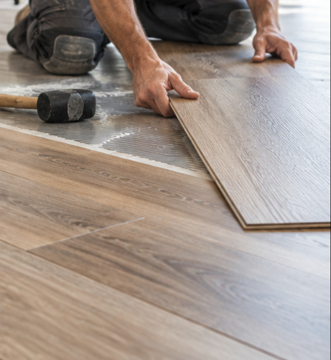 Installer laying wood-look plank flooring